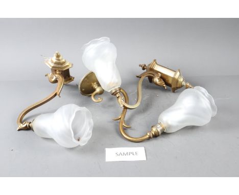 A set of four 1930s design brass scroll arm wall lights with frosted shades, and a similar wall light, arms 9" long