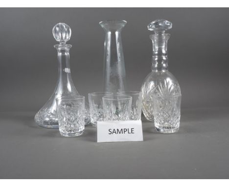 A wheel engraved carafe with fisherman design, two cut glass decanters, a set of six tumblers and other glass