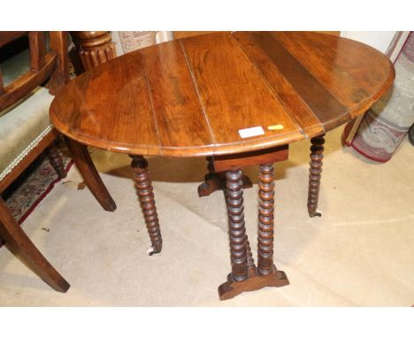 A late 19th century walnut oval Sutherland table, on bobbin turned supports, 22" wide x 29" deep x 20 1/2" high