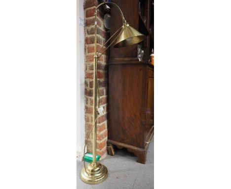A brass standard lamp, on adjustable neck and brass shade