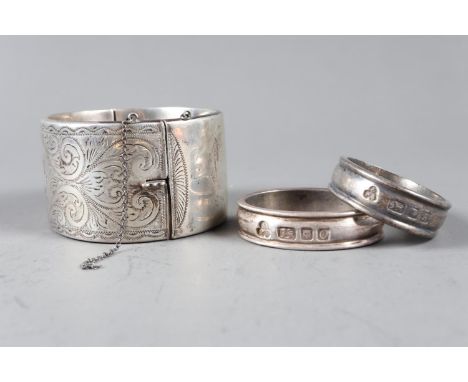 A pair of Payne &amp; Sons heavy silver napkin rings, 2.2oz troy approx, and a silver bangle, 1.9oz troy approx
