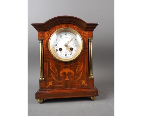 An Edwardian mahogany and inlaid arch top mantel clock with enamel dial and eight-day striking movement, 11 1/2" high