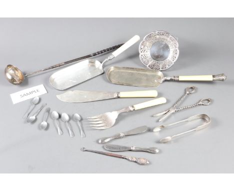A white metal punch ladle with whale bone handle, two plated crumb scoops, a pair of fish servers, two coasters and other pla