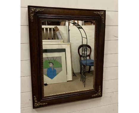 A wooden framed mirror details on the edges 