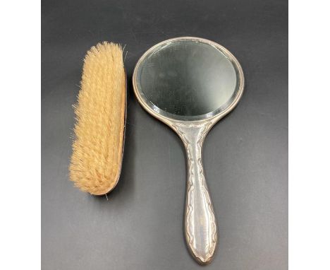 A hallmarked silver backed dressing table mirror and brush