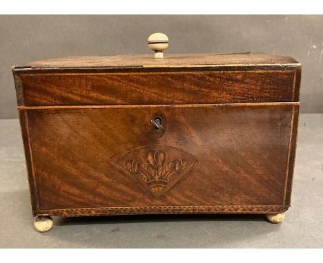 A mahogany inlaid tea caddy on ball feet AF