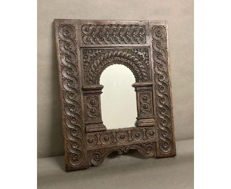 A wooden carved wall mirror with floral and scrolling detail 49x61