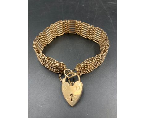 A 9ct yellow gold gate bracelet with heart shaped fastener (Approximate Total Weight 26.2g)