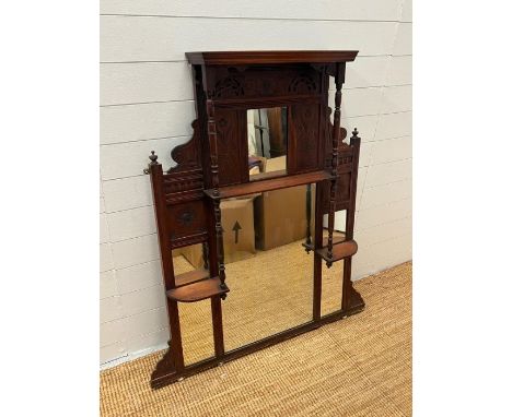 An Edwardian wall mirror, with display shelves to sides on turned supports (129cm x 90cm)