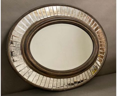 A distressed oval hall mirror with a faceted glass border 77x60