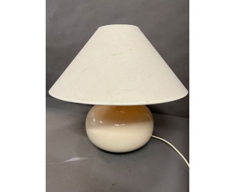 A contemporary cream table lamp