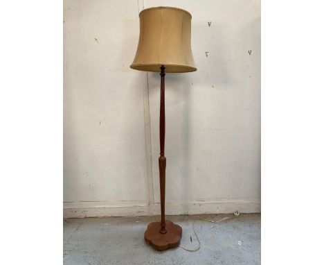 A mahogany standard lamp on turned central column 