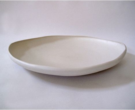 A Modern ceramic dish in off-white clay by Rina Menardi, 63X53cm, H5cm.