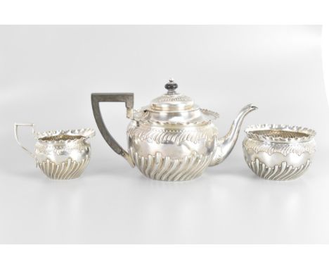 A Victorian silver three piece tea service, by Vale Brothers & Sermon, hallmarked Birmingham 1890, the teapot having an eboni