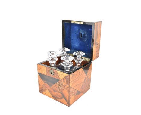 A circa 1900 Japanese parquetry decanter box, decorated with offset panels of specimen woods, the interior fitted with four f