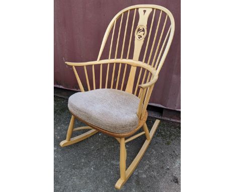 A vintage Ercol light elm and beech 'Swan Back' rocking chair on sleigh rockers, turned legs united by a crinoline stretcher,