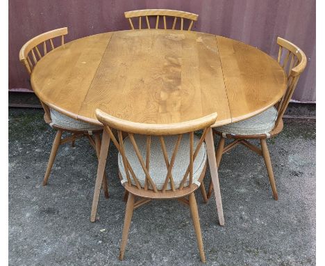 A 1960s Ercol blond elm 'Windsor' model 384 fall flap kitchen table and four model 376 beech and elm dining chairs, the table