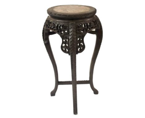 A Chinese hardwood plant pedestal with marble inset above carved and pierced foliage on four scroll legs, 94cm high