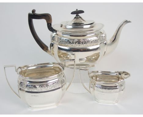 A late Victorian three piece silver tea service by Mark Willis, Sheffield 1899, of rounded rectangular shape with canted corn