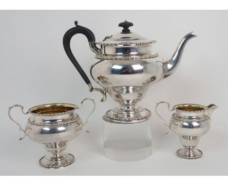 A George V three piece silver tea service by Martin Hall & Company Limited, Sheffield 1912, of tapering baluster shape with b