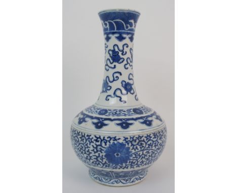 A Chinese blue and white baluster vase painted with precious objects, chrysanthemum heads on a vermiculated ground, stiff lea