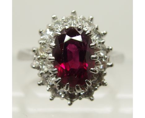 An 18ct white gold ruby and diamond cluster ring diamonds estimated approx 0.70cts, dimensions of ruby approx 8mm x 5.8mm x 4