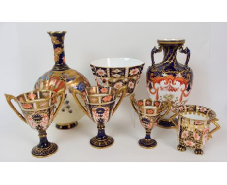 A near pair of Royal Crown Derby 1128 Imari twin handled goblets a smaller example, a slop bowl, a two handled pot, a moon fl