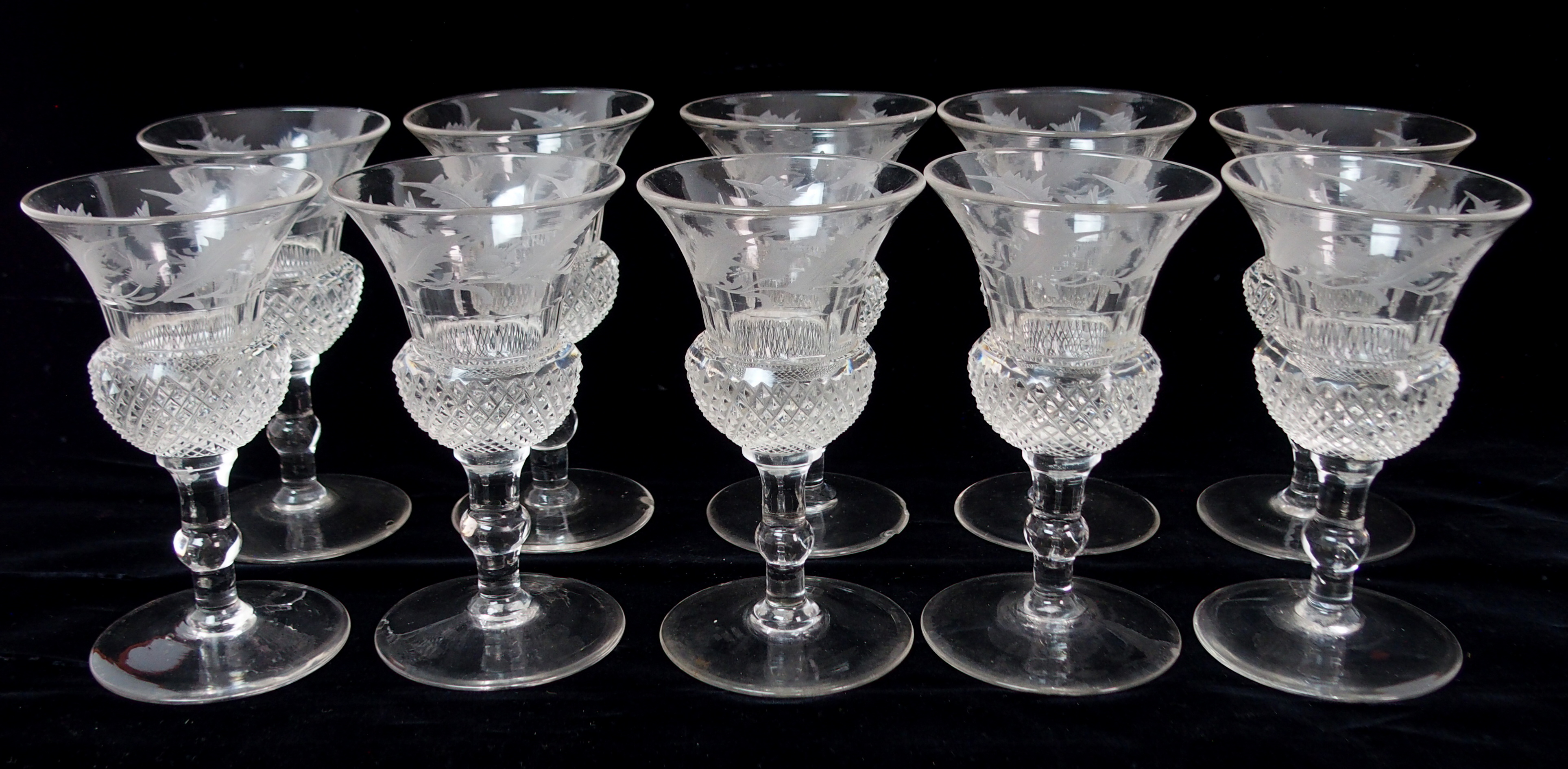 A set of Edinburgh crystal thistle shaped drinking glasses including