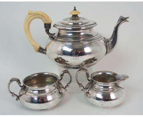 A three piece silver tea service by the Goldsmiths and Silversmiths Company Limited, London 1931, of globular shape, the cove