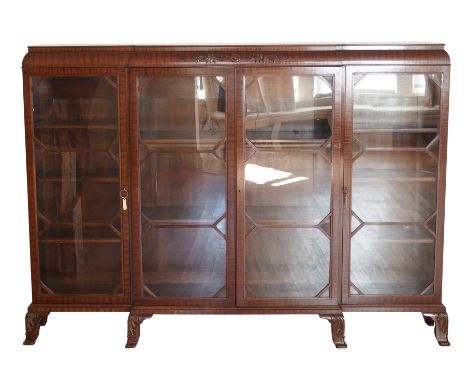 An Edwardian mahogany breakfront library bookcase circa 1925 in George III style, with Neo-Classical relief carved frieze, as
