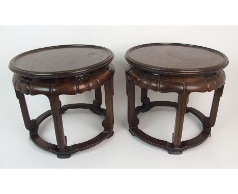 A pair of Chinese hardwood vase stands with carved and pierced frieze above five reeded scroll legs joined by stretchers, 31c