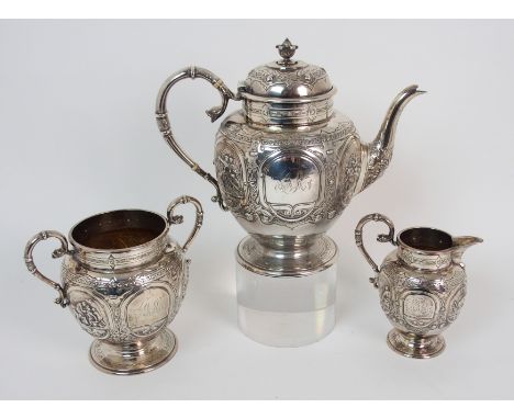 An Edwardian three piece tea service by James Reid & Company, Glasgow 1908, of globular shape with banded Celtic embossed dec