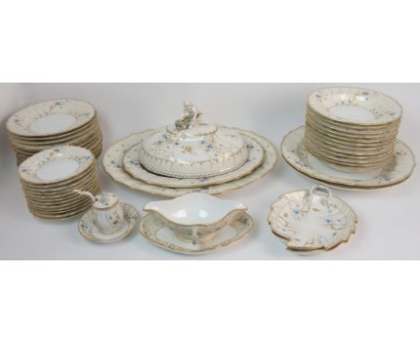 A KPM porcelain dinner service the cream ground with osier relief band, with painted blue flowers and gilt decoration, compri