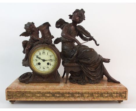 A French spelter clock Melodie, after Moreau the red veined marble base mounted with a woman playing a violin with a cherub h