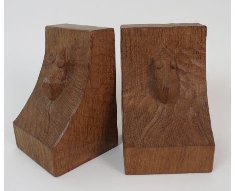 A pair of Robert 'Mouseman' Thompson oak bookends each carved with a single signature mouse, 15cm high (2)