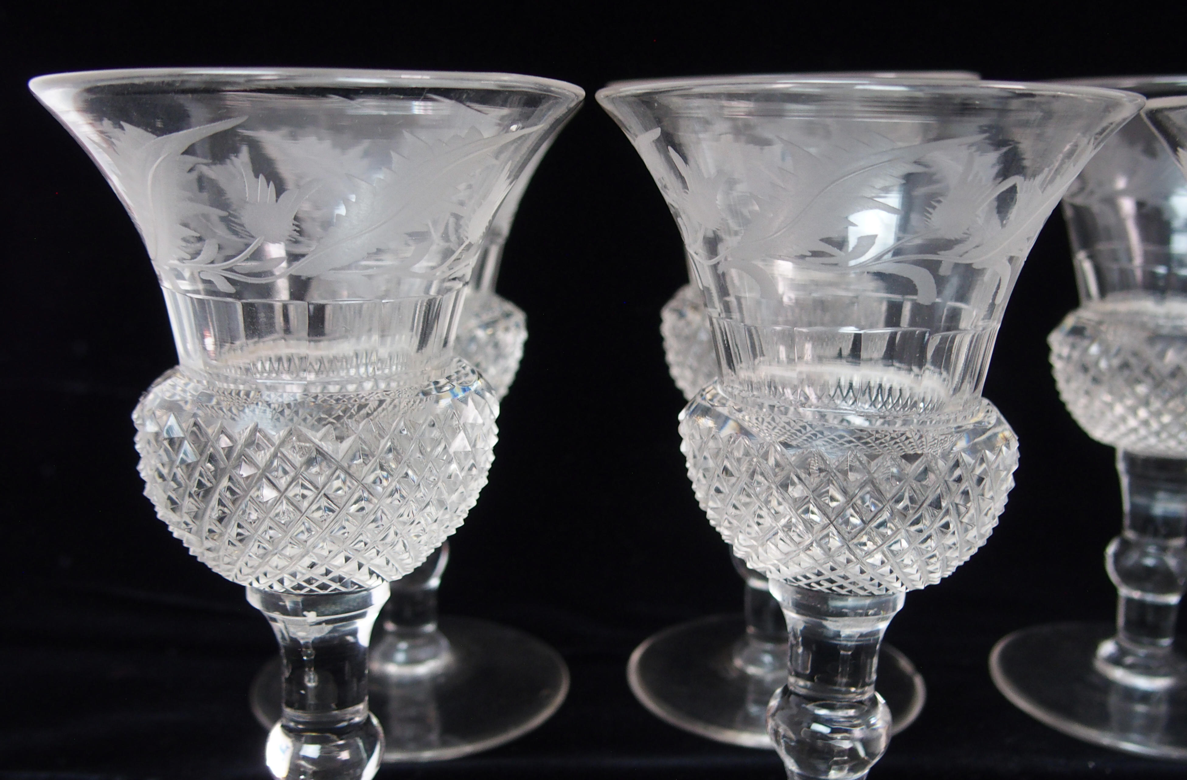 A set of Edinburgh crystal thistle shaped drinking glasses including