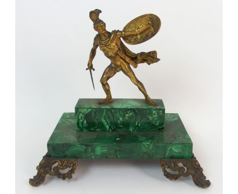 An early 19th century malachite veneered desk stand modelled as a gilded Gladiator in a fighting stance, this section lifts o