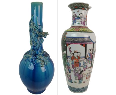 A large Chinese blue glazed vase decorated in high relief with a dragon wrapped around amongst waves (damage to dragon's mout