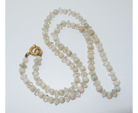 A string of white opal and glass beads length 45cm, weight 11.7gms