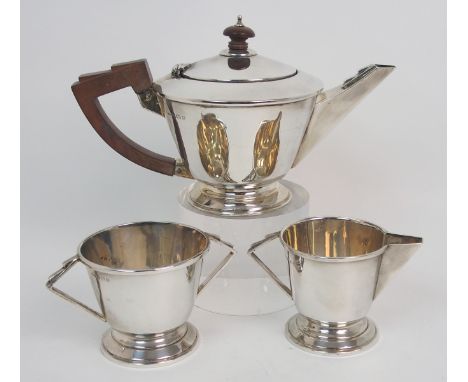 An Art Deco silver three piece bachelor's tea service by J. W. Tiptaft &amp; Son Limited, Birmingham 1933, of inverted conica