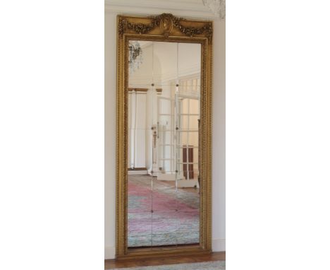 A Neo Classical Style giltwood and gesso pier mirror decorated with a female profile portrait set with ribbon tied swags abov