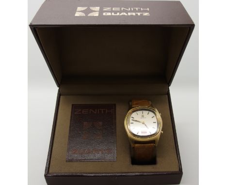 A Gents Zenith quartz watch with gold coloured case, baton numerals and digital aperture. Original brown leather strap. Case 