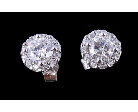  A pair of diamond cluster earrings,   the central brilliant cut diamonds, estimated to weigh  0.90 carats total, claw set wi