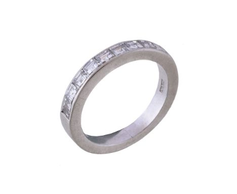  A nine stone diamond ring,   the ring set with step cut diamonds channel set in a platinum setting, approximately 0.90 carat