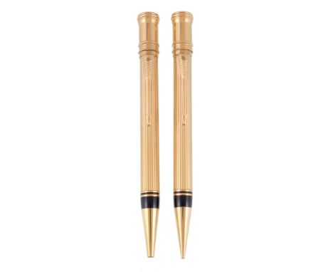  Parker, Duofold, a gold plated ballpoint pen and propelling pencil,   with reeded decoration, arrow clips and a Parker leath