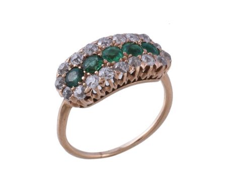  A late Victorian emerald and diamond panel ring,   circa 1900, the five circular cut emeralds within a surround of old cut d