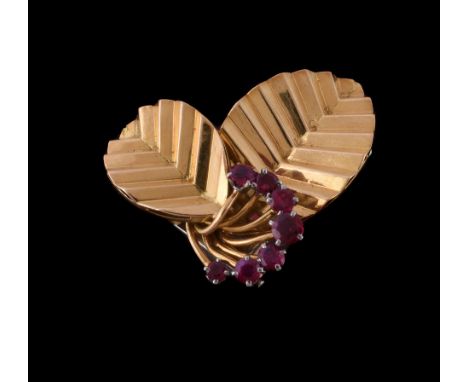  A 1960s 18 carat gold ruby double prong clip brooch by Gubelin,   designed as two leaves with a semi circle of graduated cir