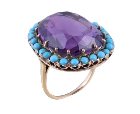  An amethyst and turquoise ring,   the cushion cut amethyst claw set within a surround of circular cabochon turquoise, finger