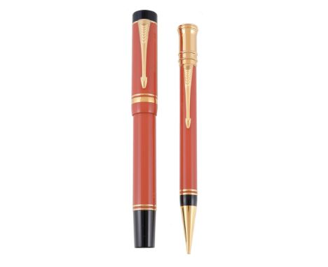  Parker, Duofold, a limited edition orange fountain pen and propelling pencil,   circa 1990, the fountain pen cap with a gilt