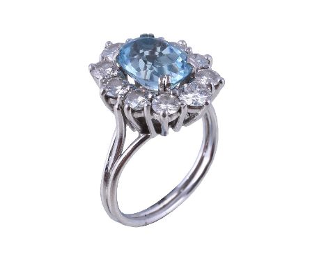  A French diamond and aquamarine cluster ring,   the oval cut aquamarine within a surround of brilliant cut diamonds, 1.40 ca